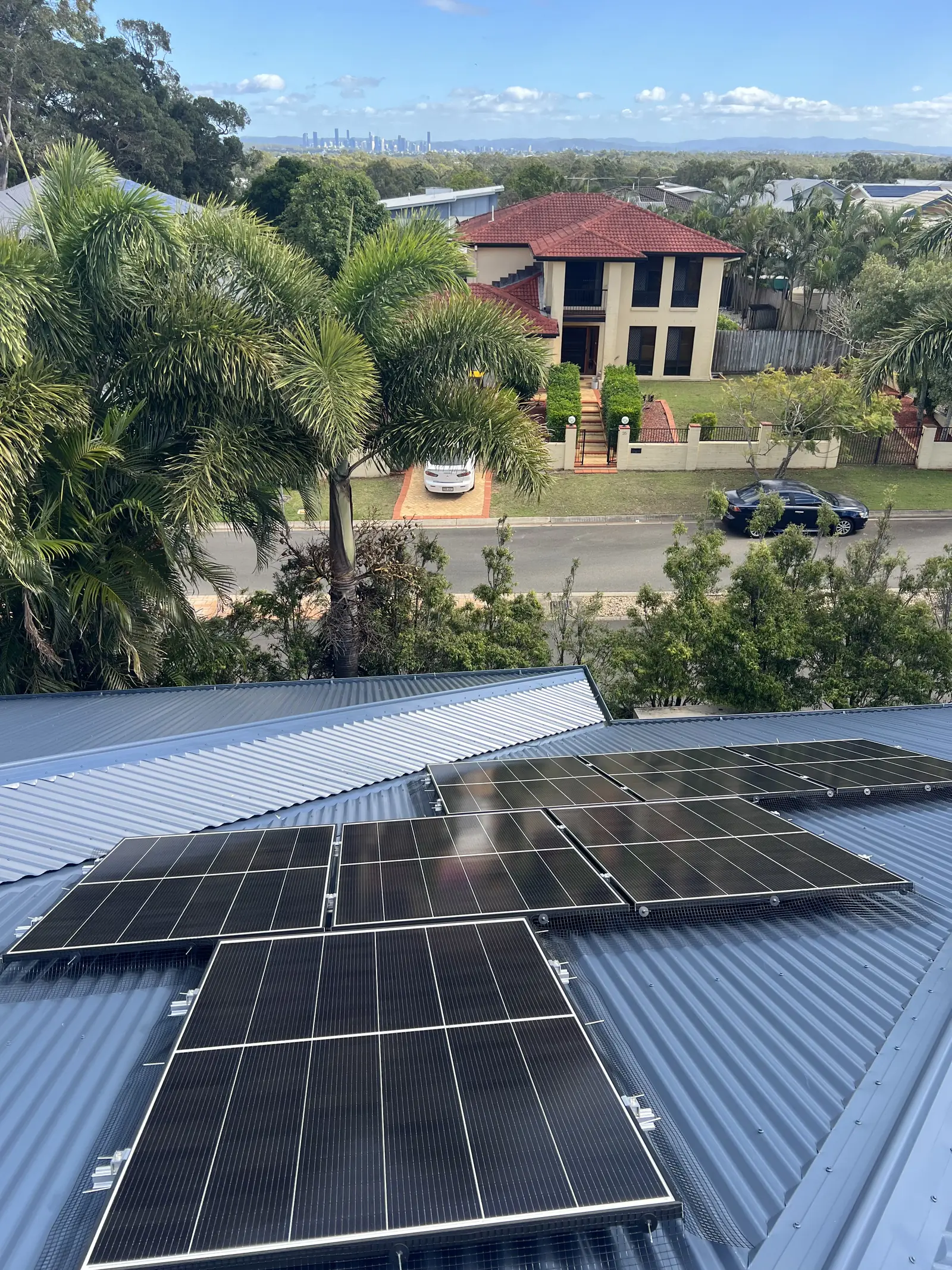 Solar panels on a two-storey Brisbane home viewed from the roof
